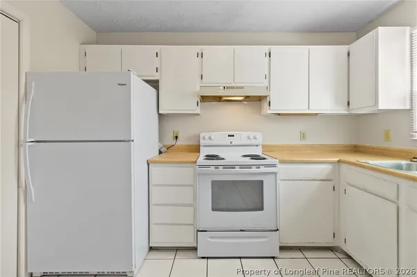 a kitchen with cabinets and stainless steel appliances