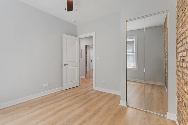 an empty room with windows and closet