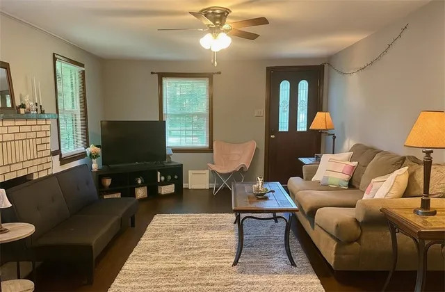 a living room with furniture fireplace and a flat screen tv