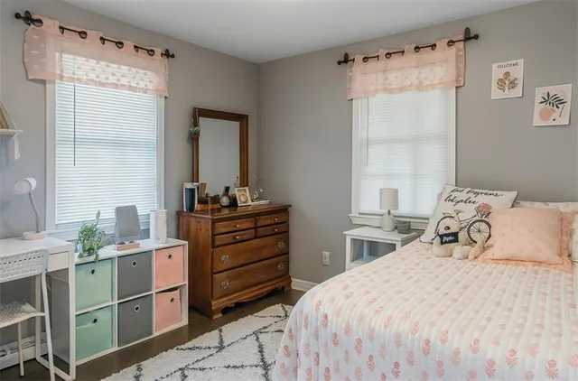 a bedroom with a bed and a mirror on dresser