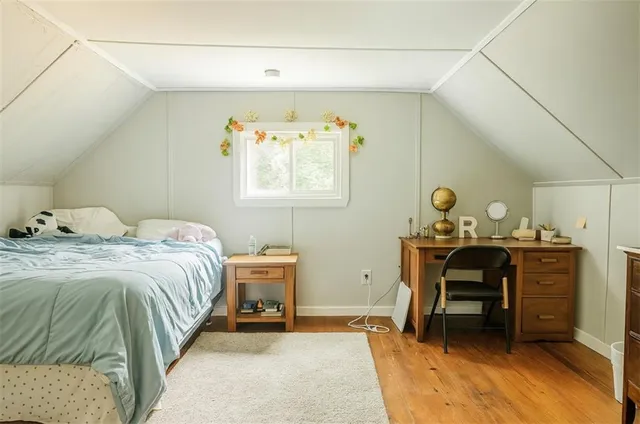 a bedroom with a bed and a table