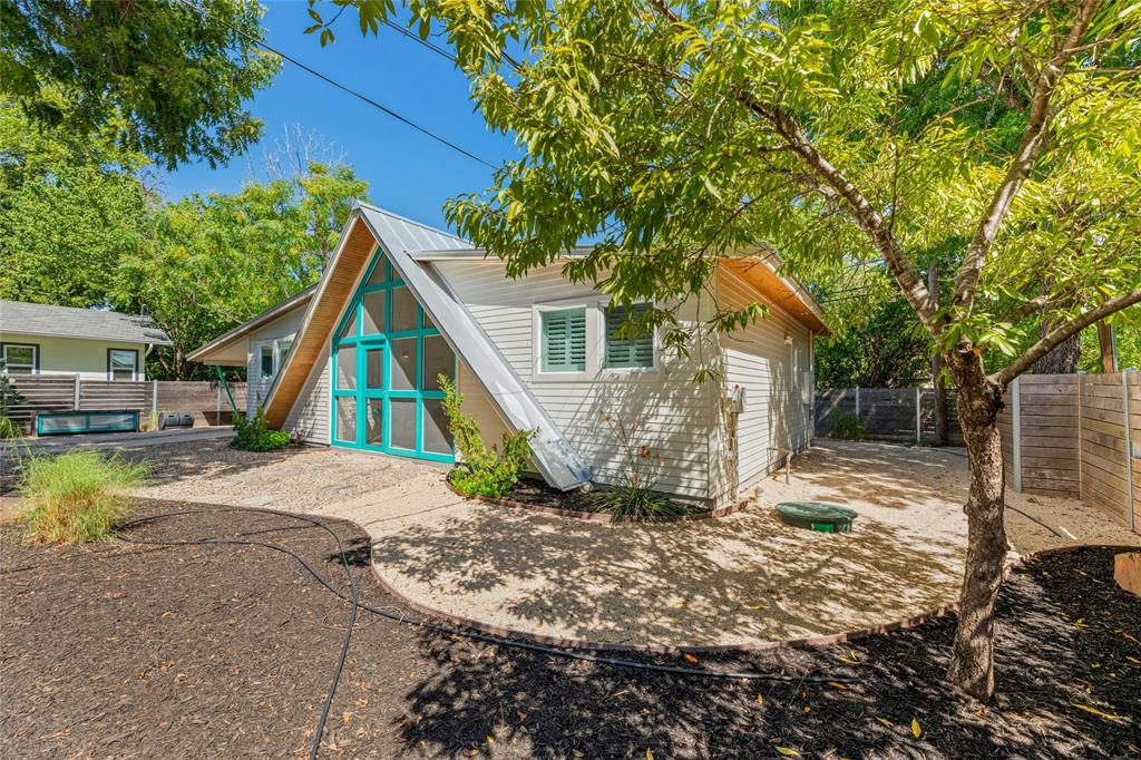 a view of a house with a yard and sitting area