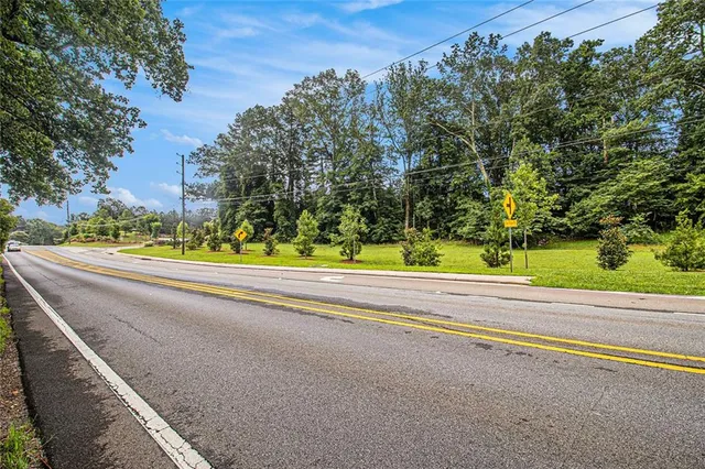 a view of a field with trees in the background