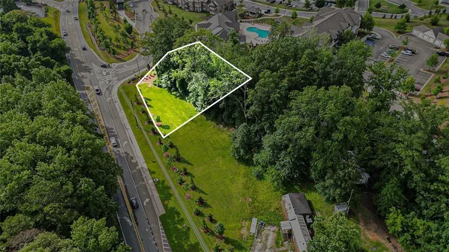 an aerial view of a house with a yard