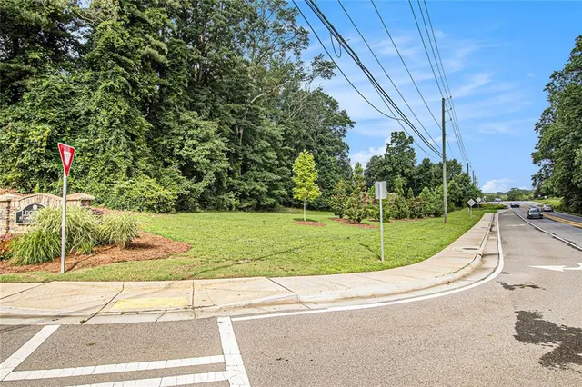 a view of a road with a houses in the background