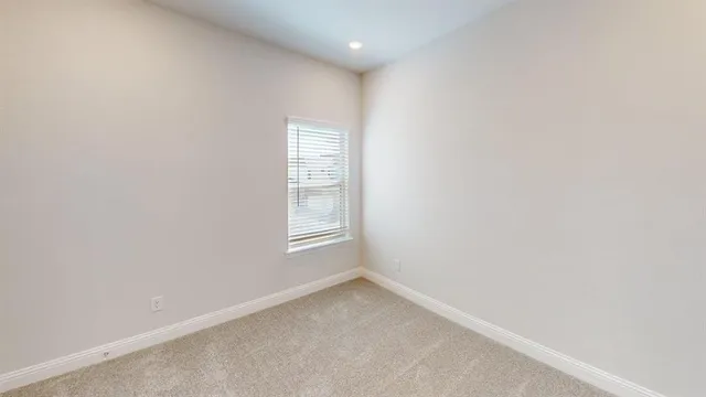 a view of an empty room and a window