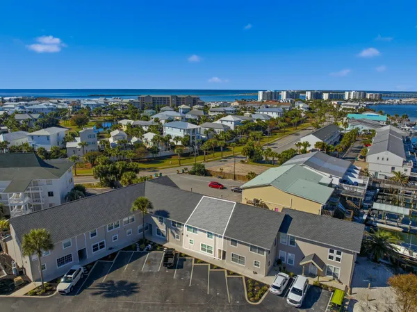 an aerial view of a city with lots of residential buildings and ocean view