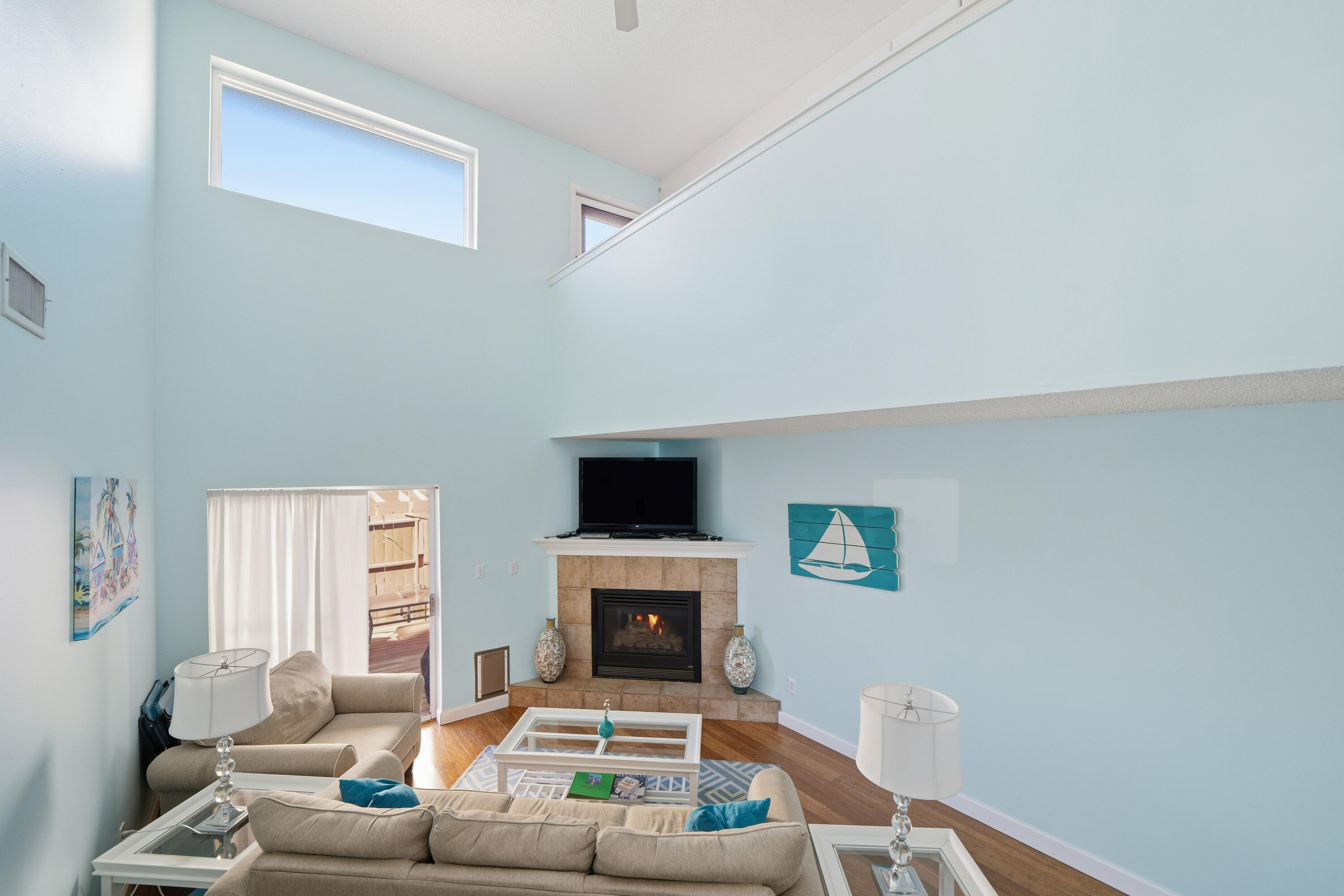 130 Durango Road, Unit 107 Destin, FL 32541 - Photo 11 of 44 a living room with furniture a fireplace and a flat screen tv