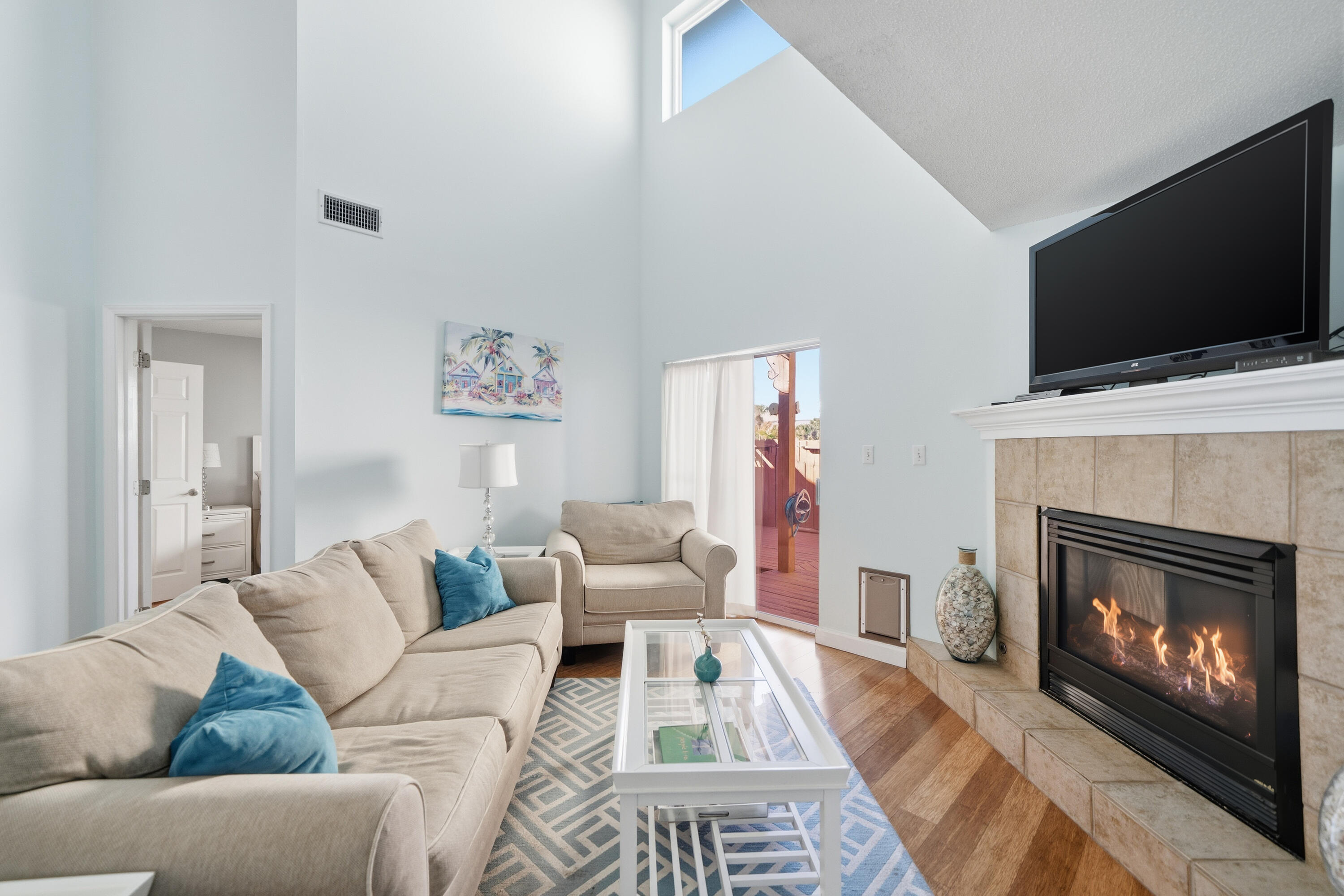 130 Durango Road, Unit 107 Destin, FL 32541 - Photo 12 of 44 a living room with furniture a flat screen tv and a fireplace