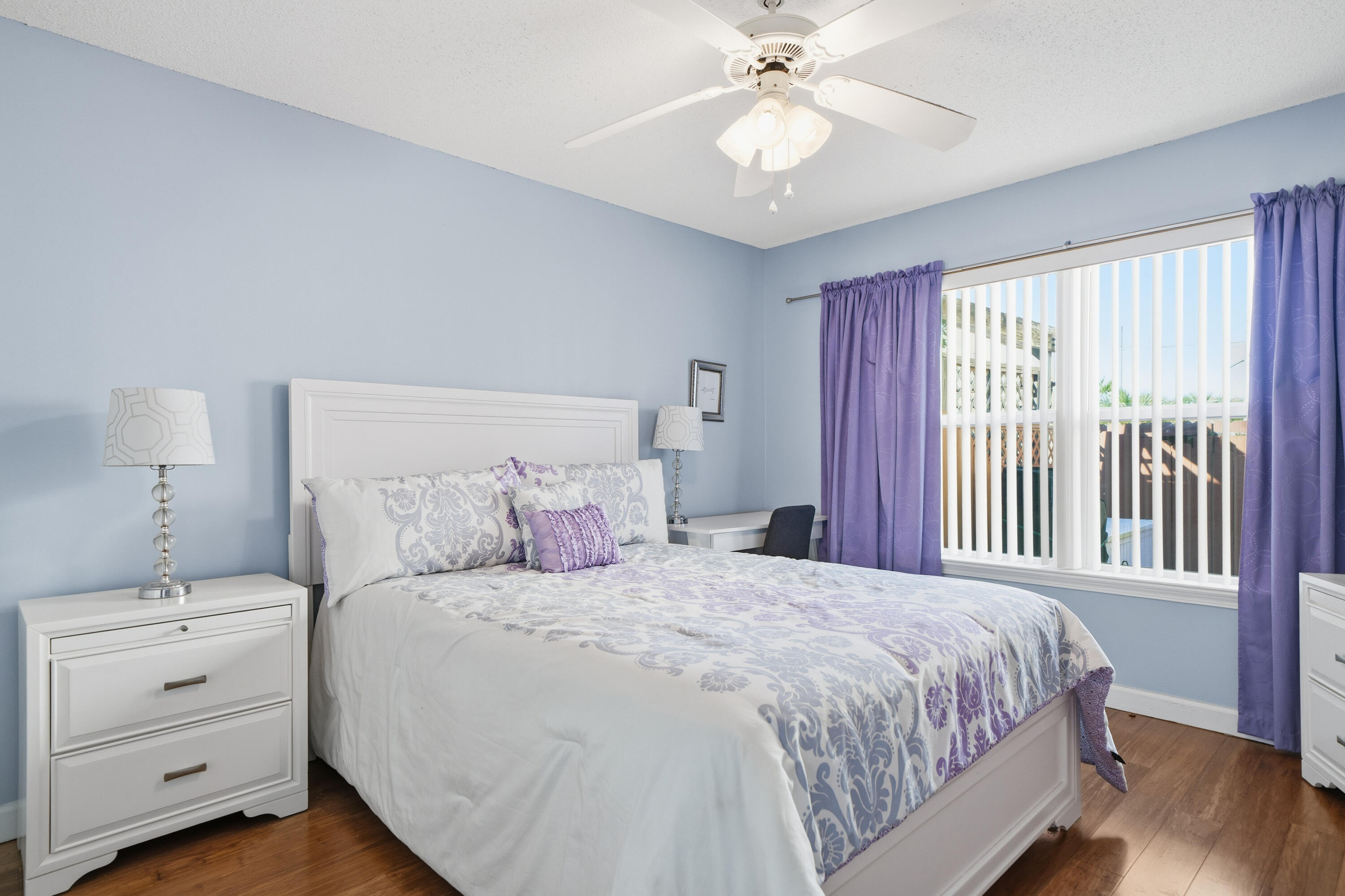 130 Durango Road, Unit 107 Destin, FL 32541 - Photo 14 of 44 a bedroom with a large bed and a chandelier