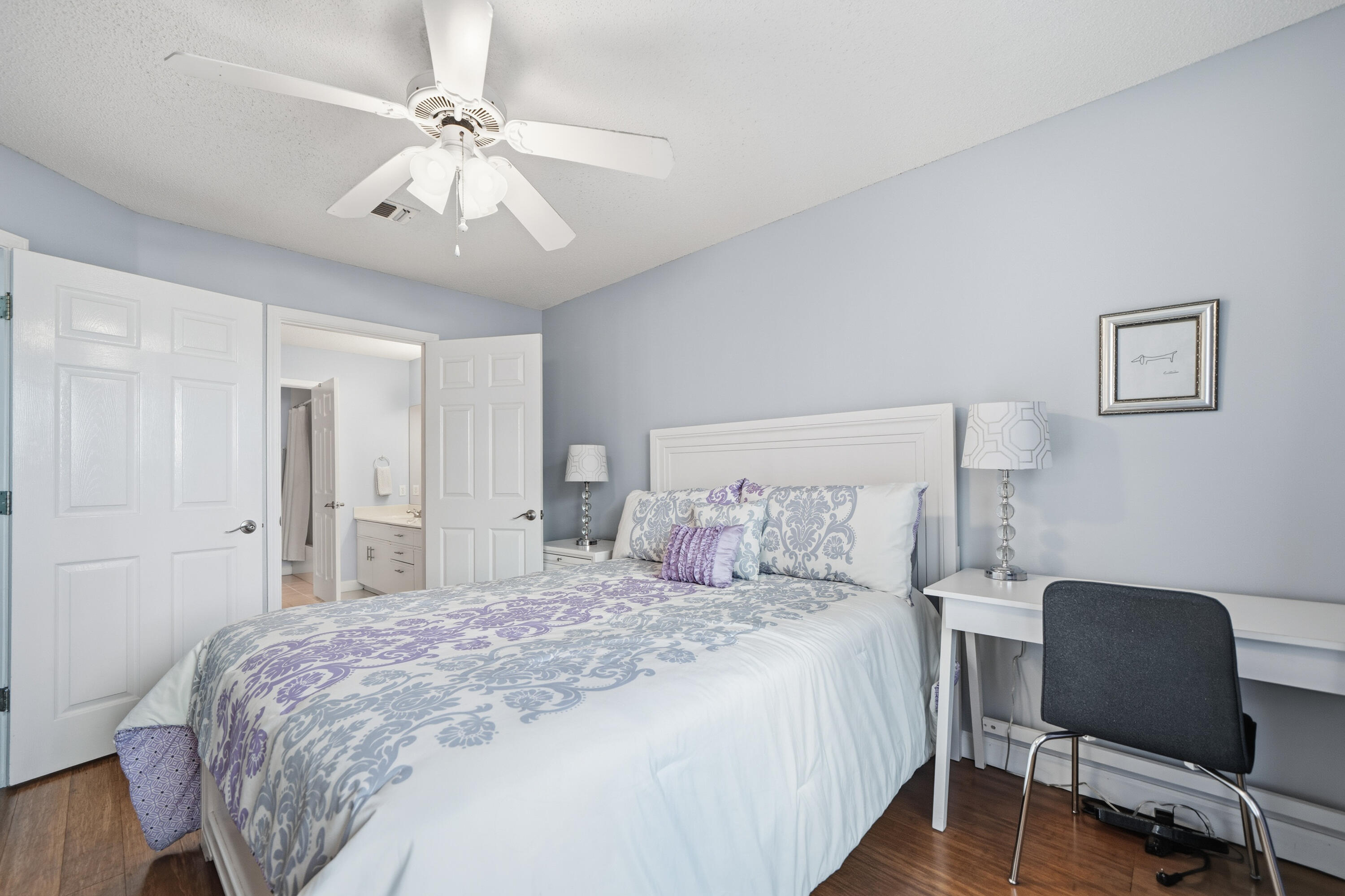 130 Durango Road, Unit 107 Destin, FL 32541 - Photo 15 of 44 a bedroom with a bed and a chair