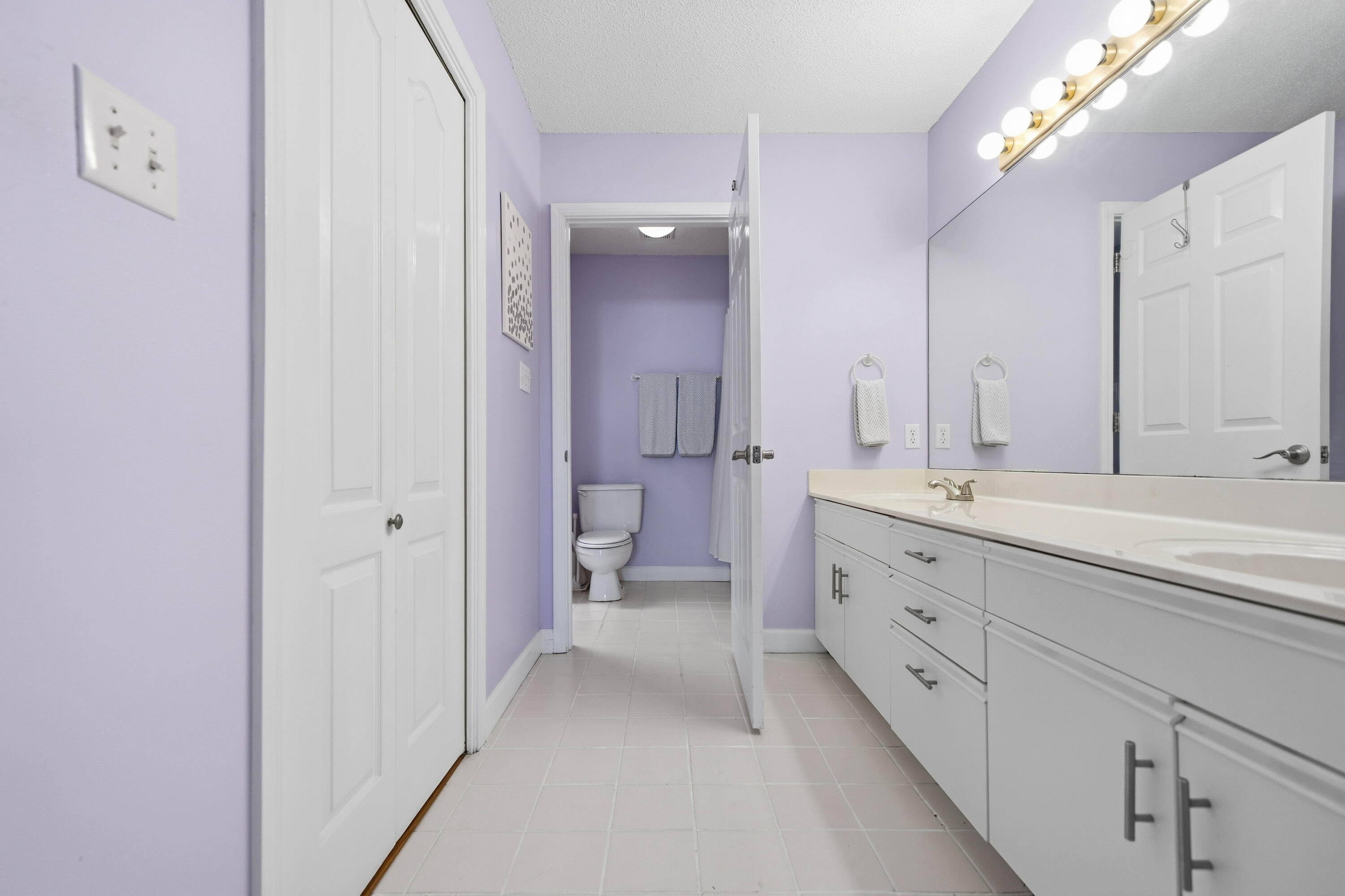 130 Durango Road, Unit 107 Destin, FL 32541 - Photo 16 of 44 a bathroom with a double vanity sink mirror and shower