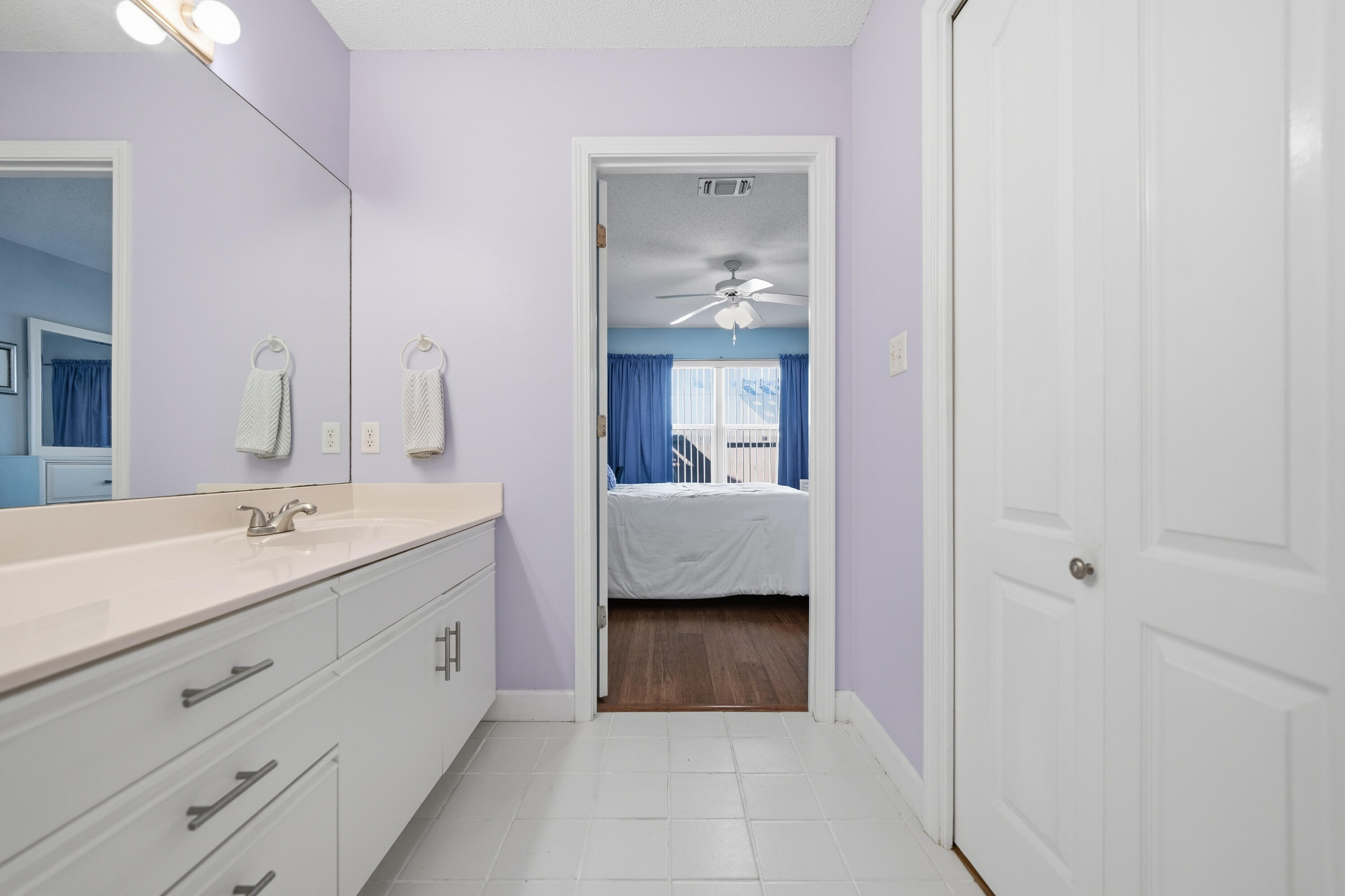 130 Durango Road, Unit 107 Destin, FL 32541 - Photo 17 of 44 a en suite bathroom with a double vanity sink and mirror