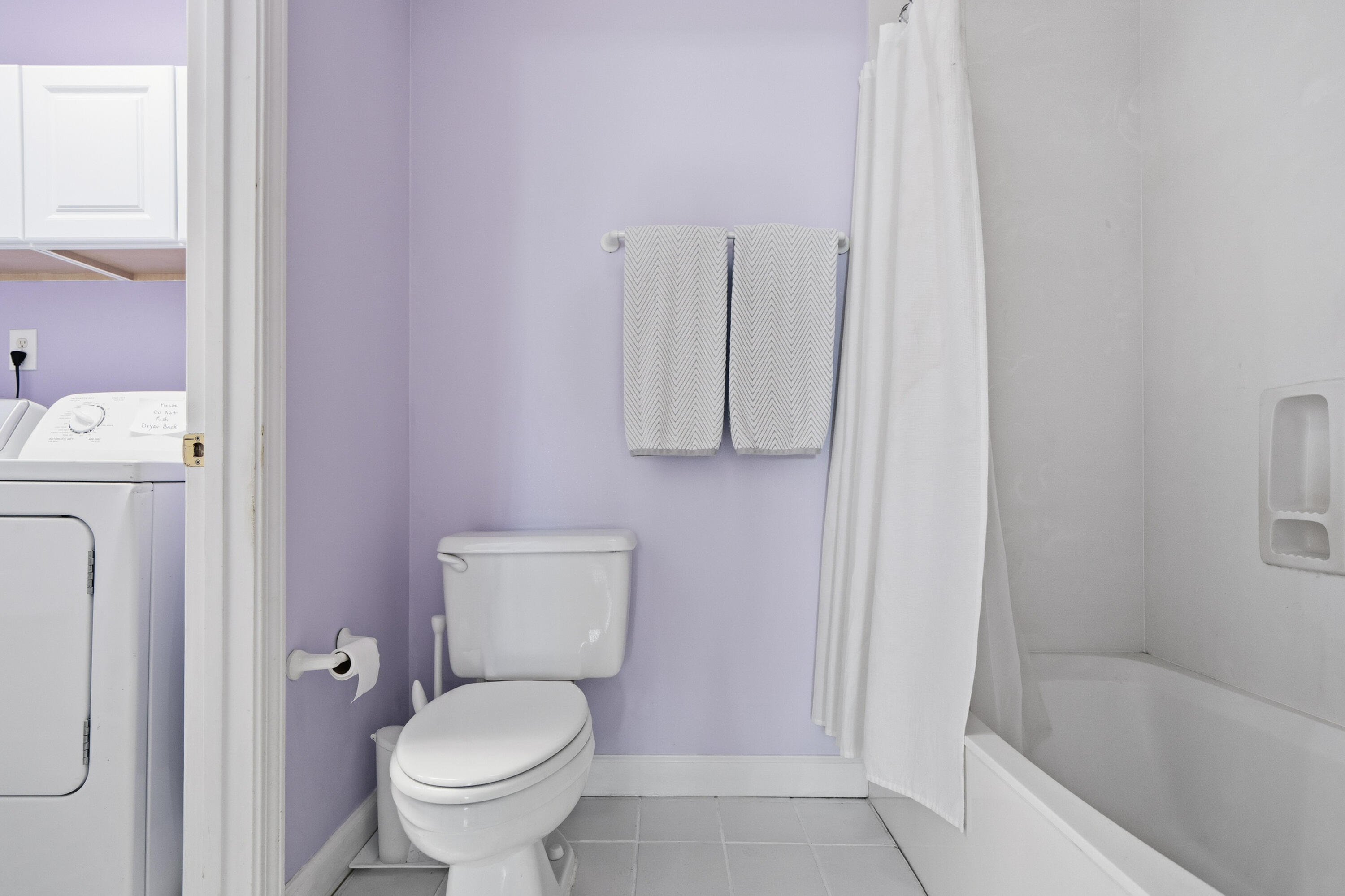 130 Durango Road, Unit 107 Destin, FL 32541 - Photo 18 of 44 a white toilet sitting next to a bath tub