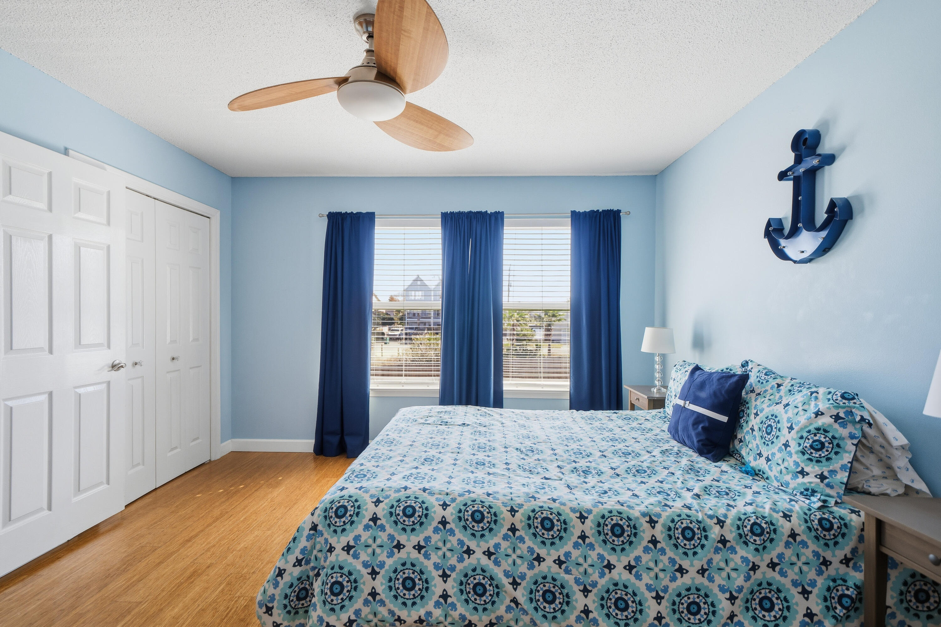130 Durango Road, Unit 107 Destin, FL 32541 - Photo 23 of 44 a bedroom with a large bed and a chandelier fan