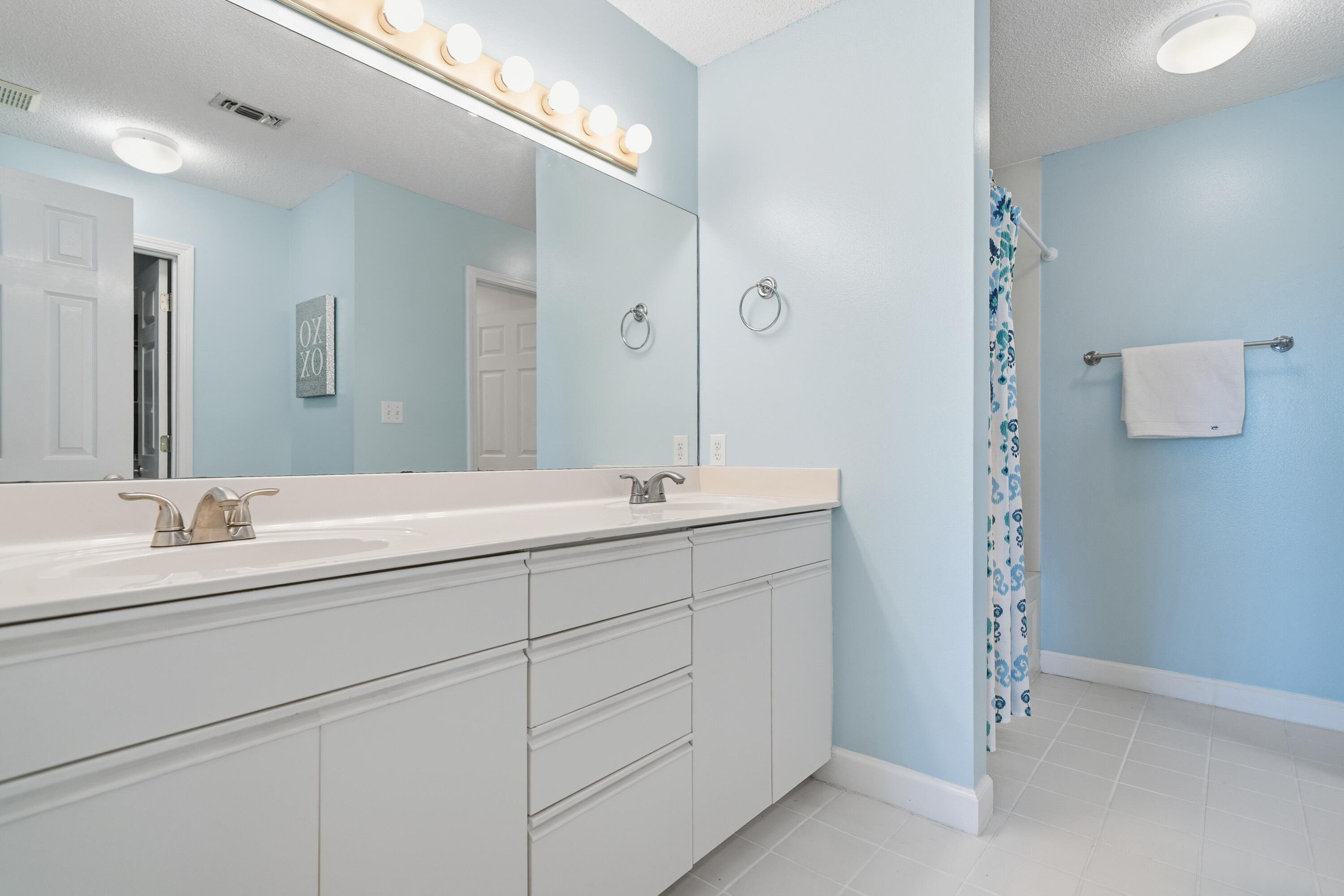 130 Durango Road, Unit 107 Destin, FL 32541 - Photo 24 of 44 a bathroom with a double vanity sink and mirror