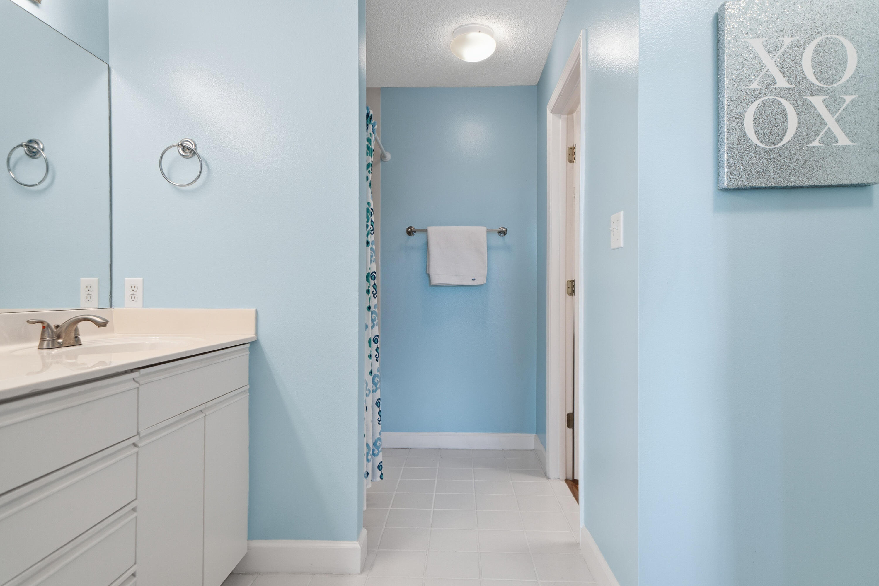 130 Durango Road, Unit 107 Destin, FL 32541 - Photo 25 of 44 a bathroom with a sink and mirror