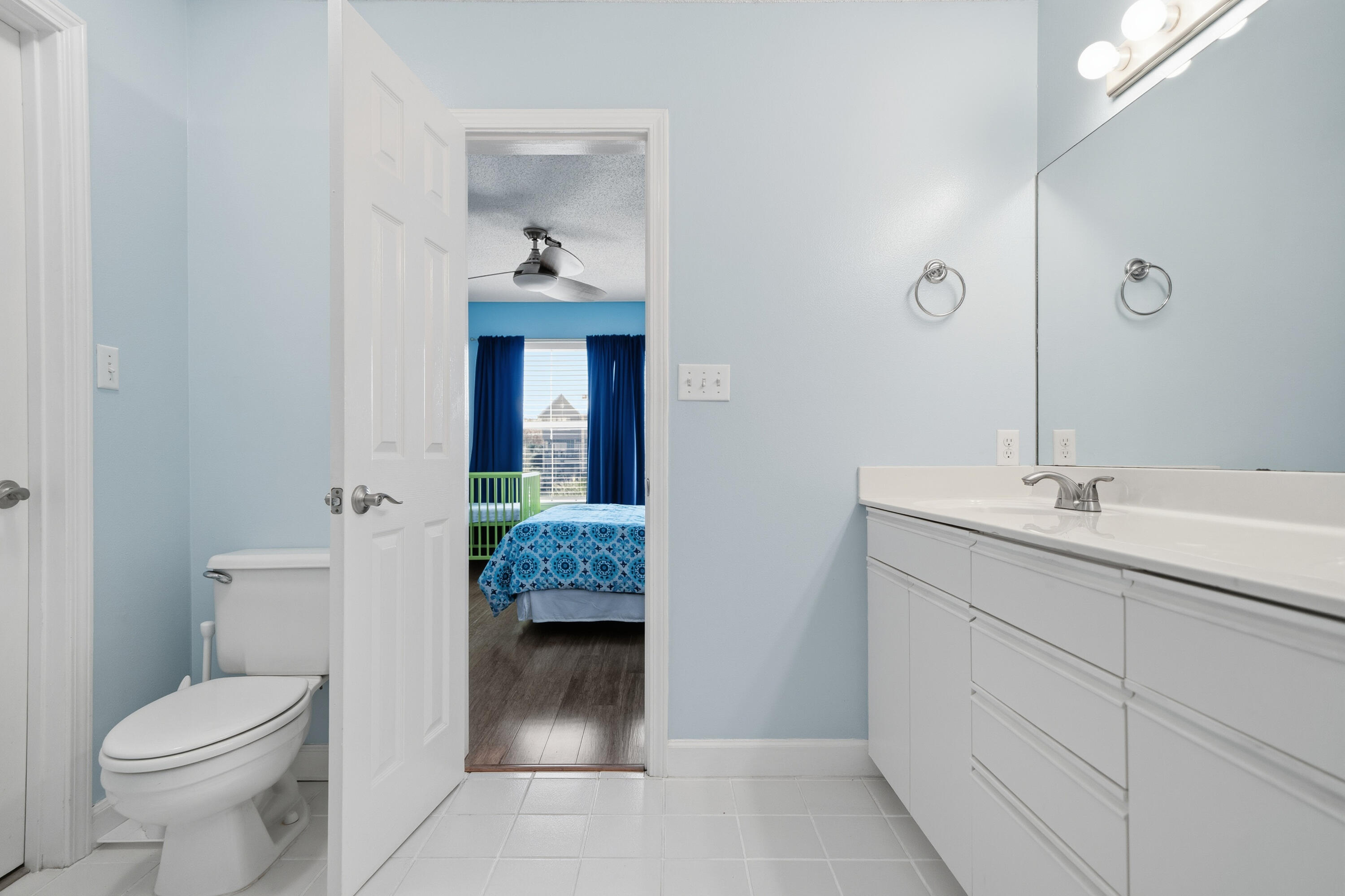 130 Durango Road, Unit 107 Destin, FL 32541 - Photo 28 of 44 a bathroom with a toilet sink and mirror