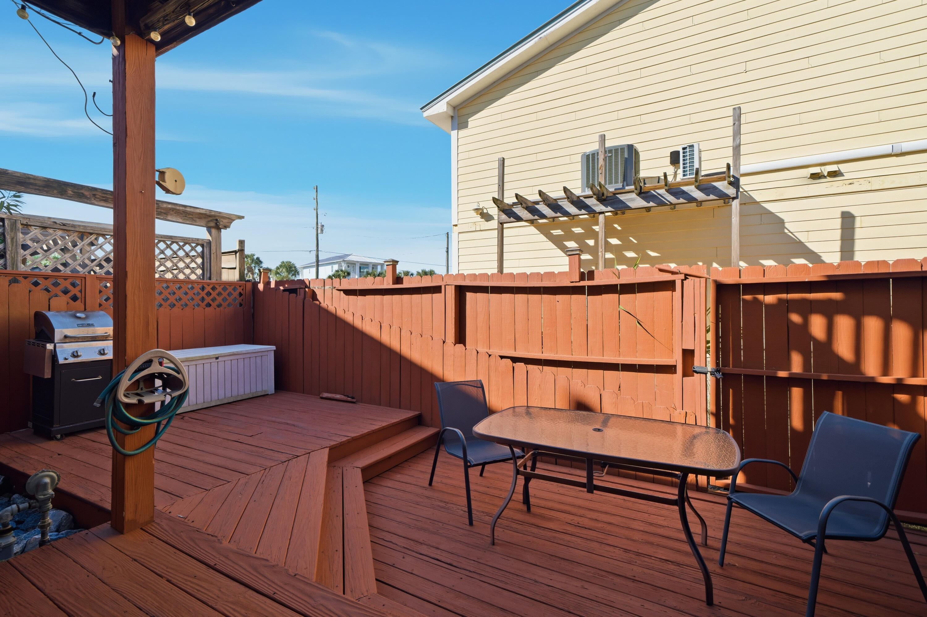 130 Durango Road, Unit 107 Destin, FL 32541 - Photo 32 of 44 a balcony with wooden floor table and chairs