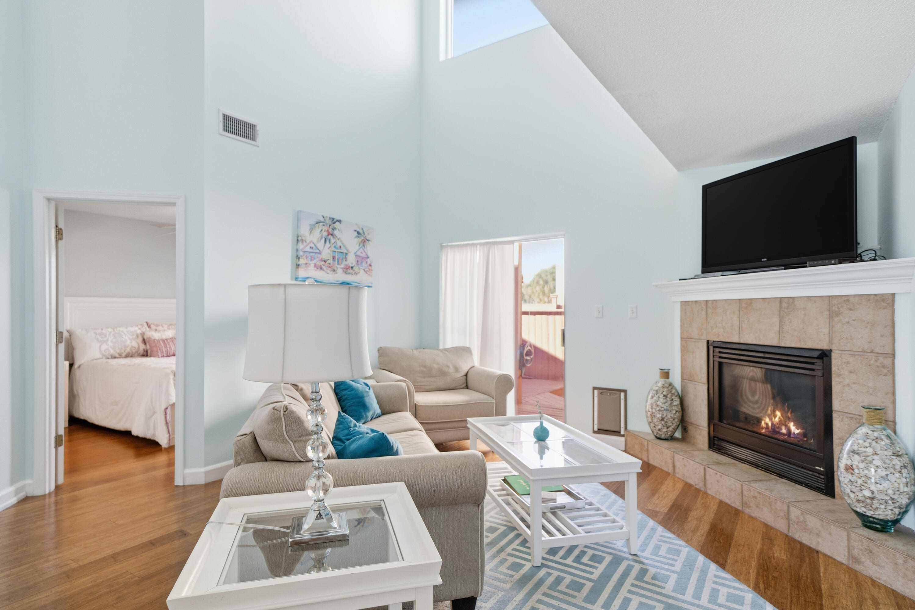 130 Durango Road, Unit 107 Destin, FL 32541 - Photo 10 of 44 a living room with furniture a fireplace and a flat screen tv