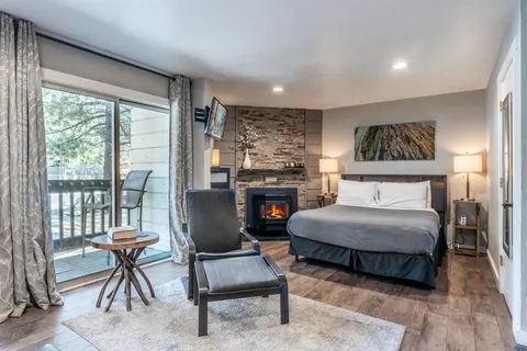 a bedroom with furniture and a fireplace