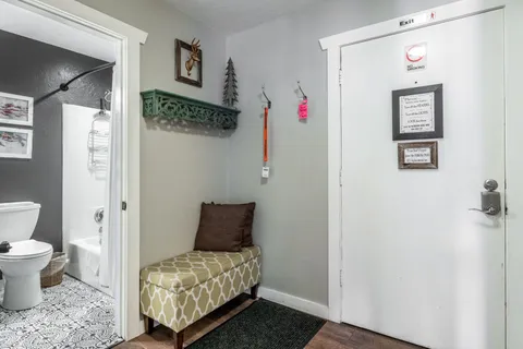 a bathroom with a toilet sink and mirror