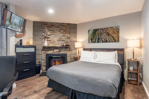 a bedroom with a bed and a fireplace