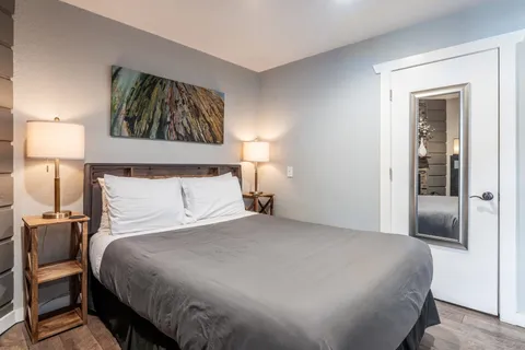 a bedroom with a bed and a lamp