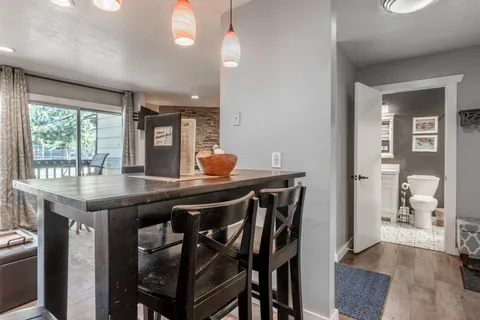 a kitchen with a table chairs and wooden floor