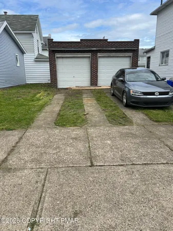 a car parked in front of white house