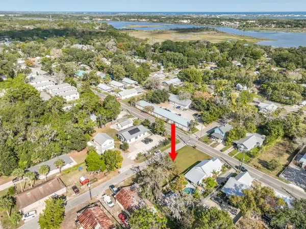 an aerial view of residential houses with outdoor space and swimming pool