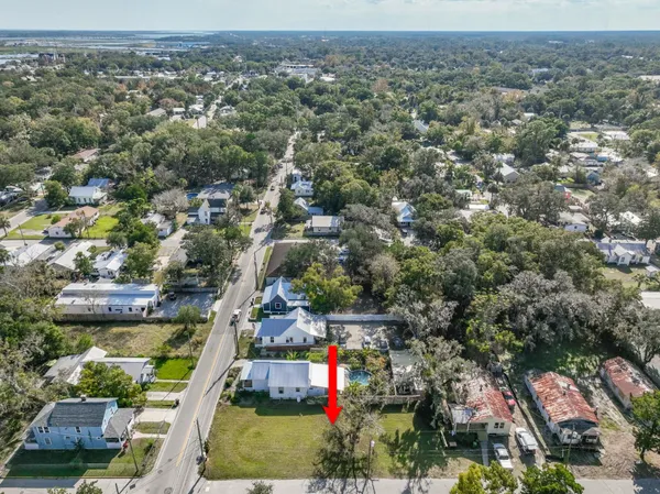 an aerial view of residential houses with outdoor space and swimming pool