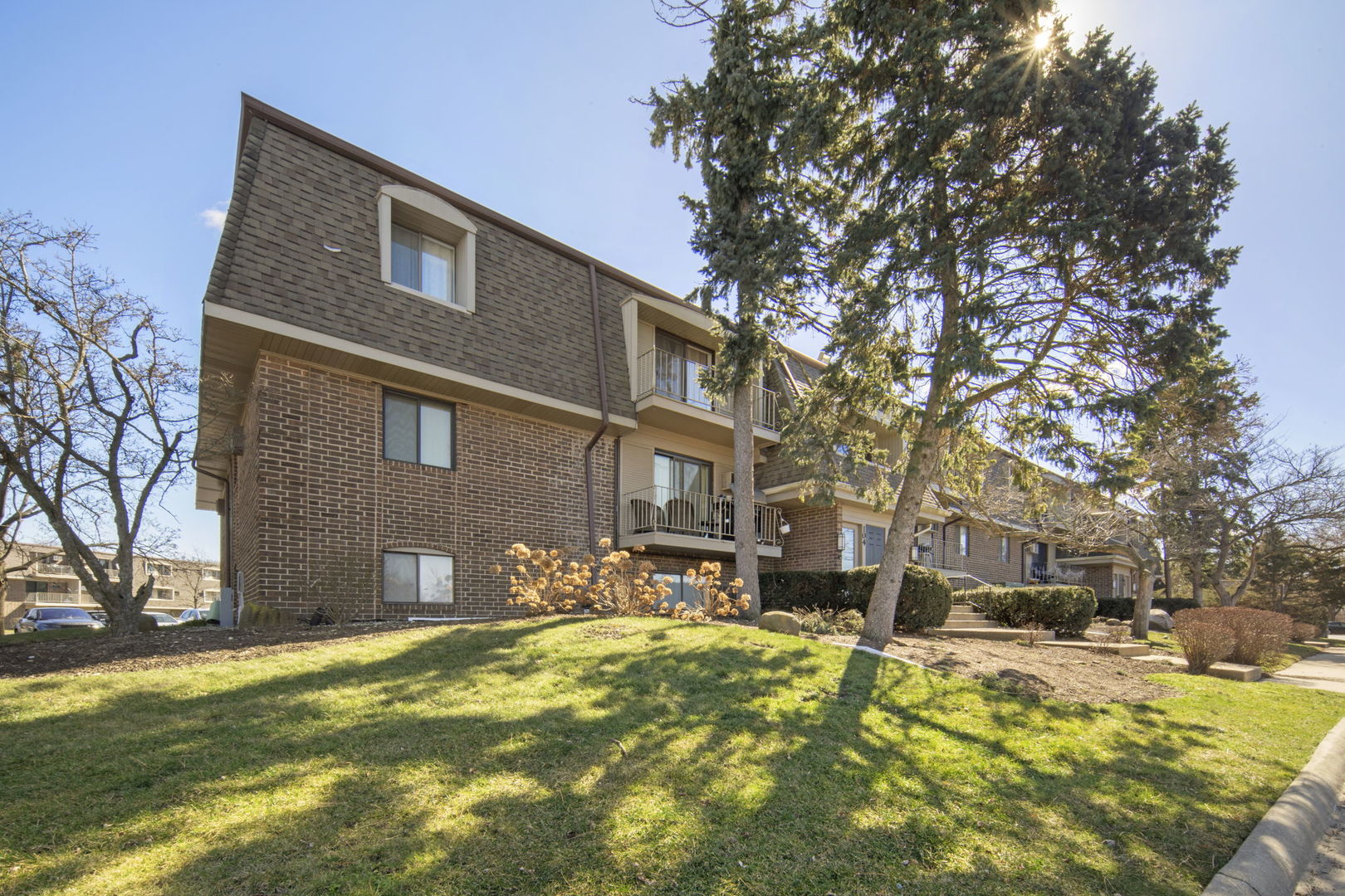 104 East Bailey Road, Unit A Naperville, IL 60565 - Photo 1 of 16 a front view of a house with a yard covered with snow