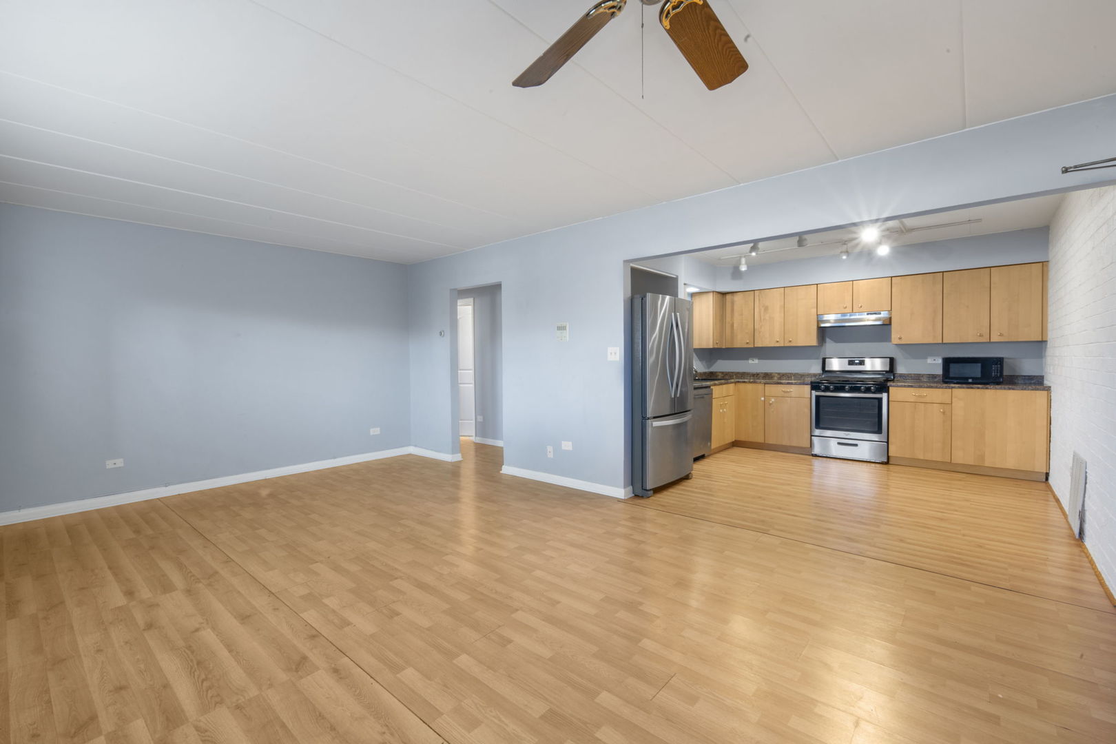 104 East Bailey Road, Unit A Naperville, IL 60565 - Photo 3 of 16 a view of a kitchen with a sink and a refrigerator
