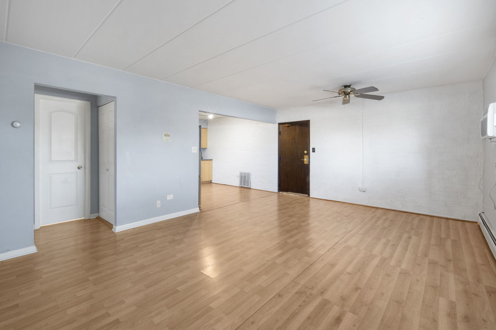 104 East Bailey Road, Unit A Naperville, IL 60565 - Photo 4 of 16 a view of a livingroom with wooden floor and a ceiling fan