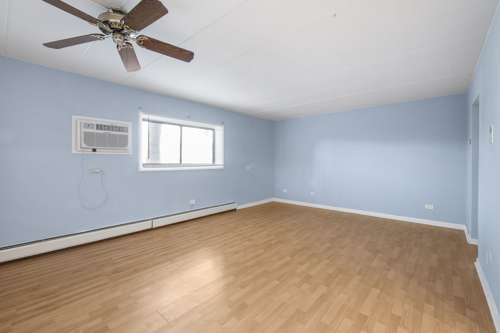 104 East Bailey Road, Unit A Naperville, IL 60565 - Photo 5 of 16 wooden floor in an empty room with a window