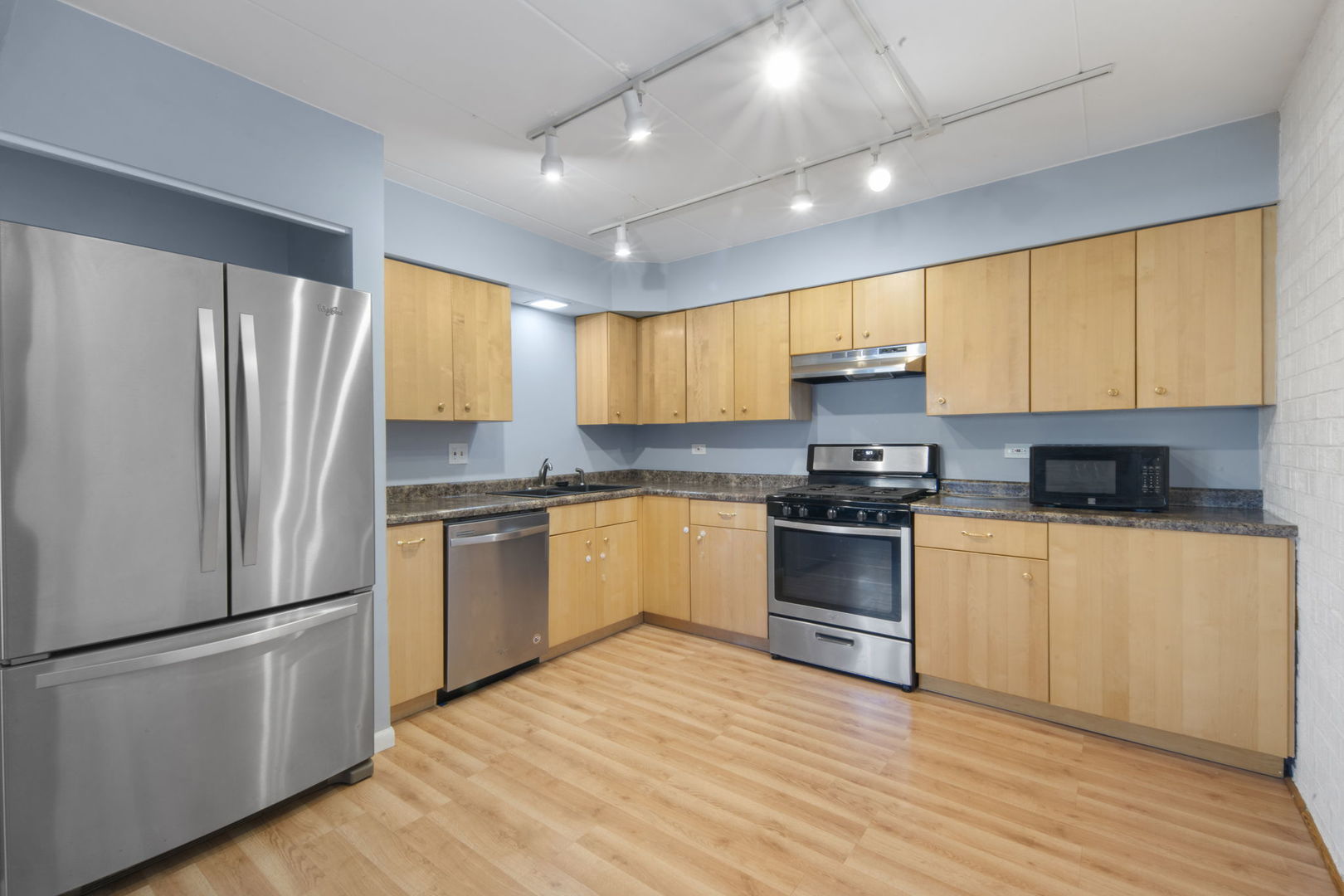 104 East Bailey Road, Unit A Naperville, IL 60565 - Photo 6 of 16 a kitchen with granite countertop a refrigerator stove top oven and sink