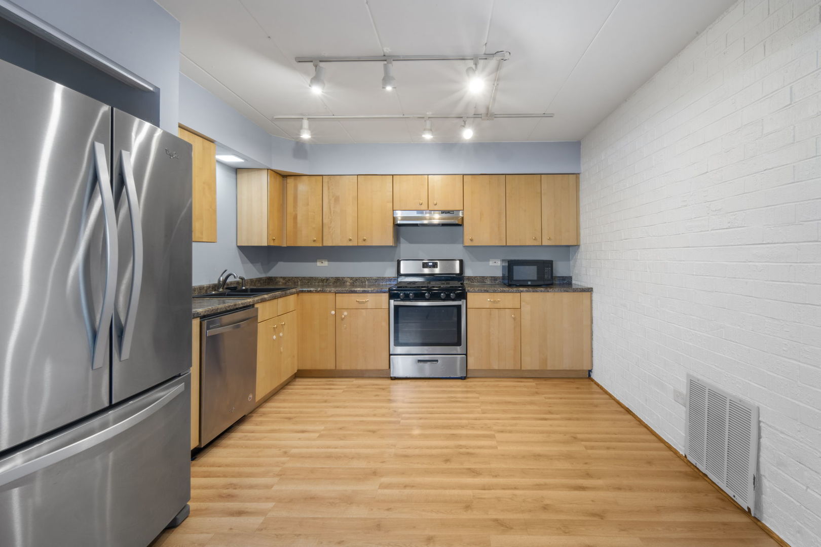 104 East Bailey Road, Unit A Naperville, IL 60565 - Photo 7 of 16 a kitchen with granite countertop a refrigerator stove top oven and sink