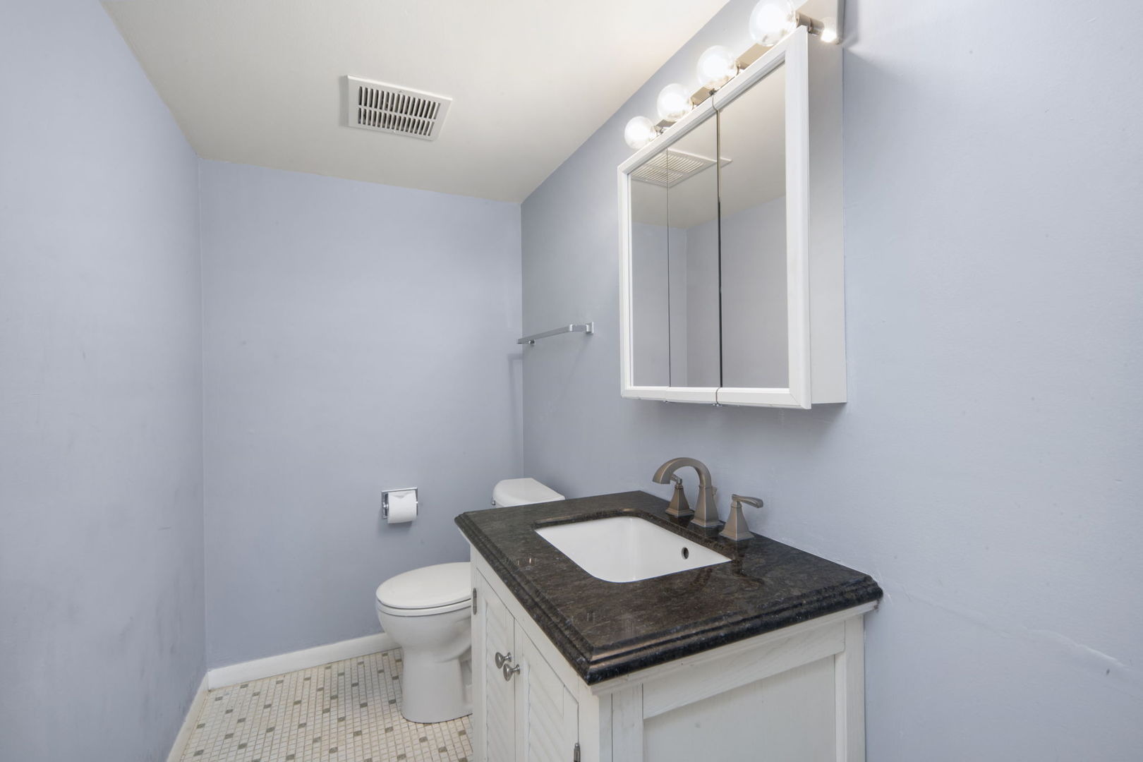 104 East Bailey Road, Unit A Naperville, IL 60565 - Photo 8 of 16 a bathroom with a granite countertop sink a toilet and a mirror