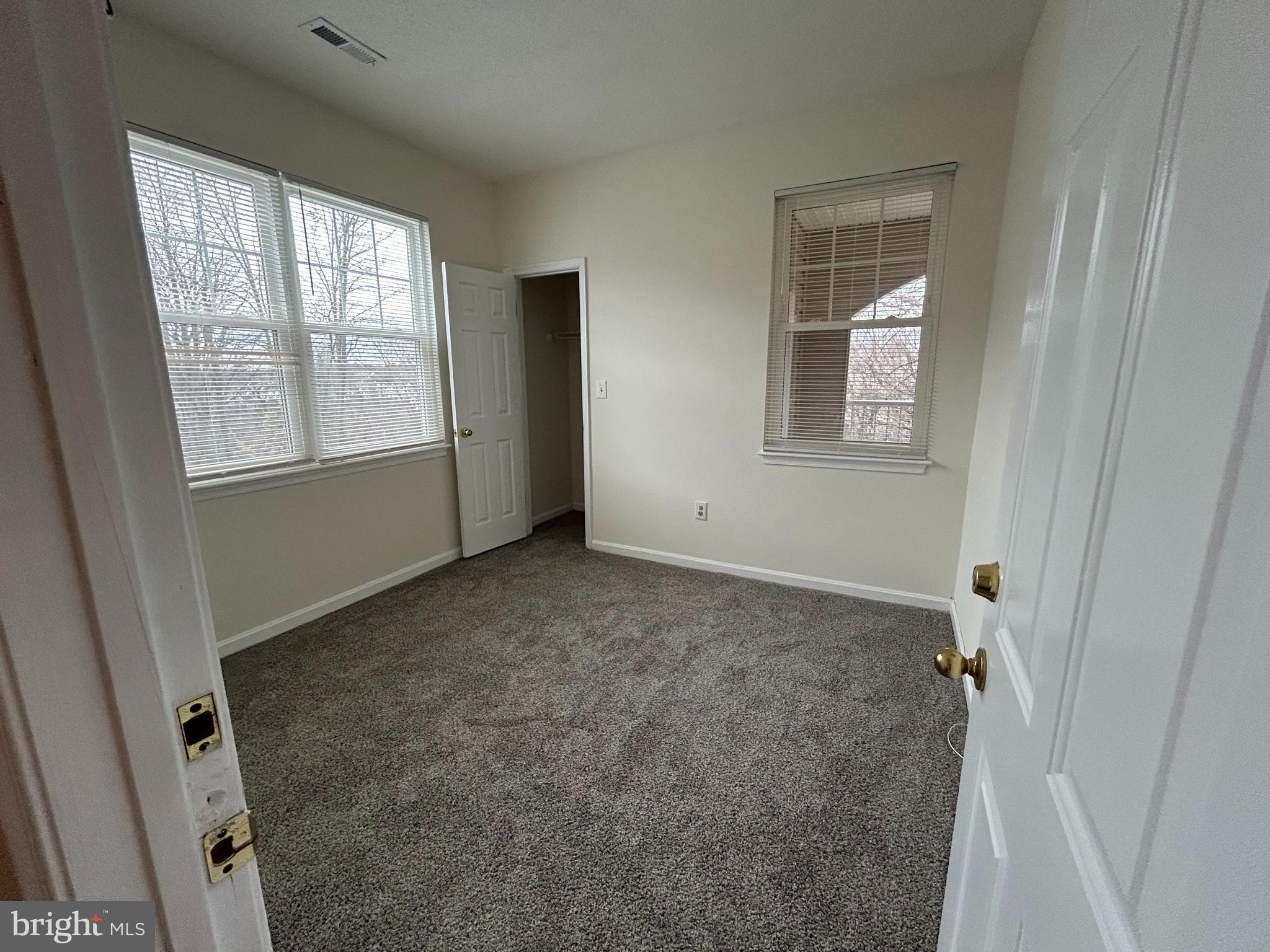 7204 Bogley Road, Unit 303 Baltimore, MD 21244 - Photo 11 of 15 an empty room with windows