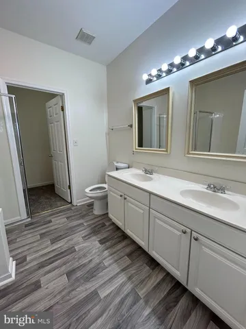 a bathroom with a double vanity sink and mirror