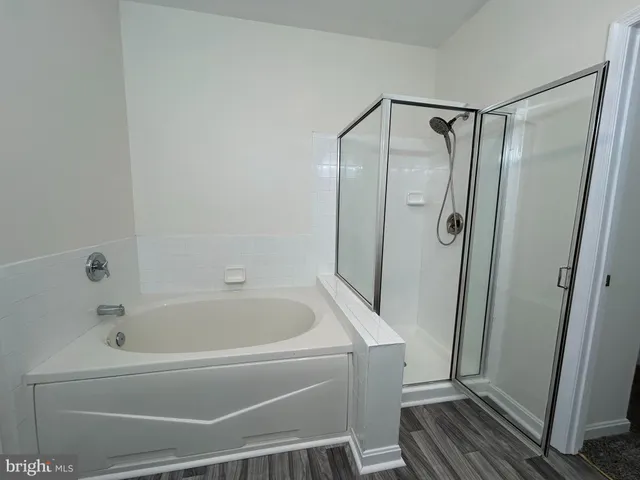 a bathroom with a bathtub and a shower