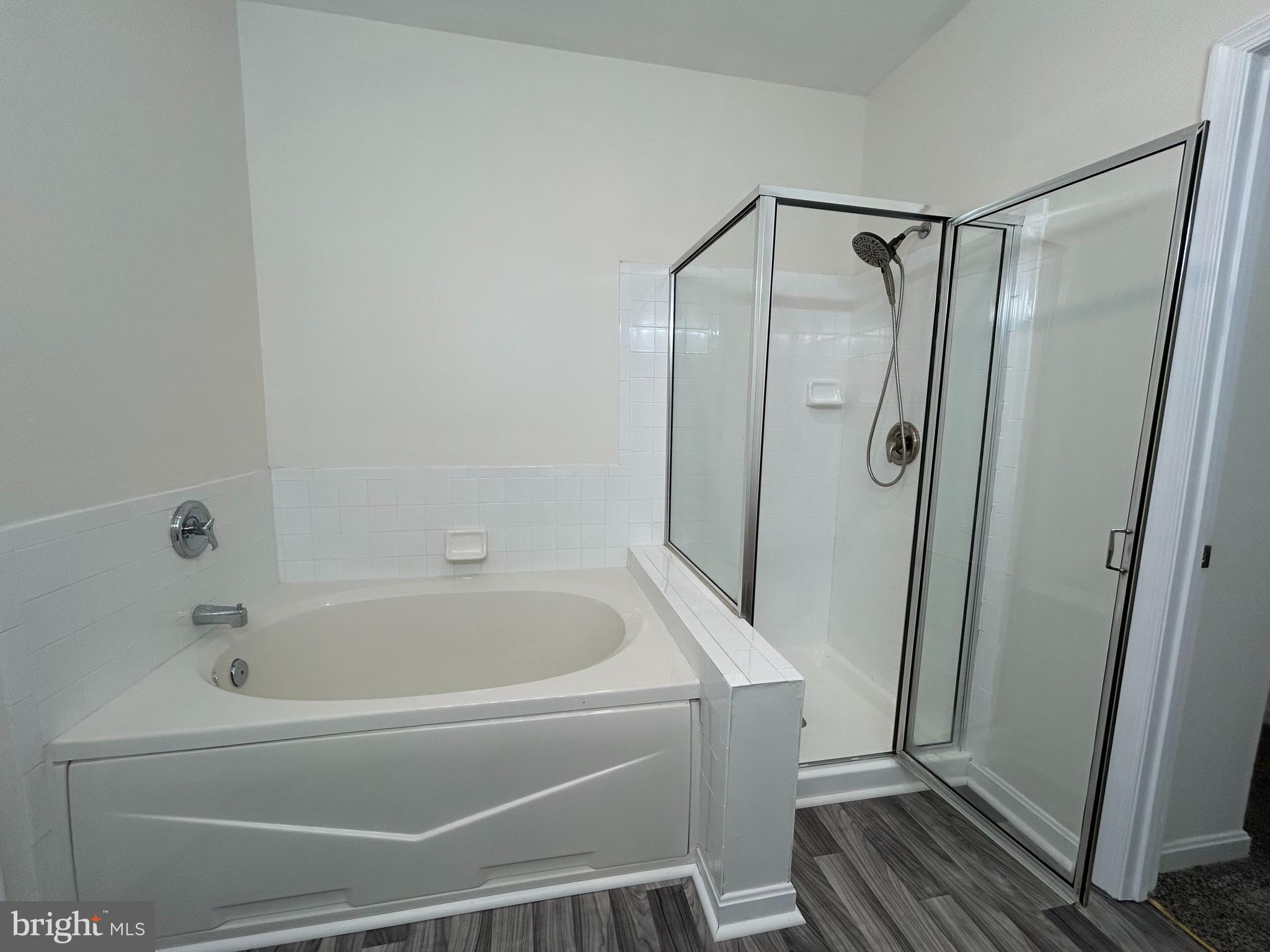 7204 Bogley Road, Unit 303 Baltimore, MD 21244 - Photo 7 of 15 a bathroom with a bathtub and a shower