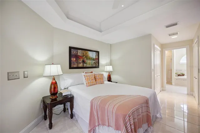 a spacious bedroom with a bed a table and chair