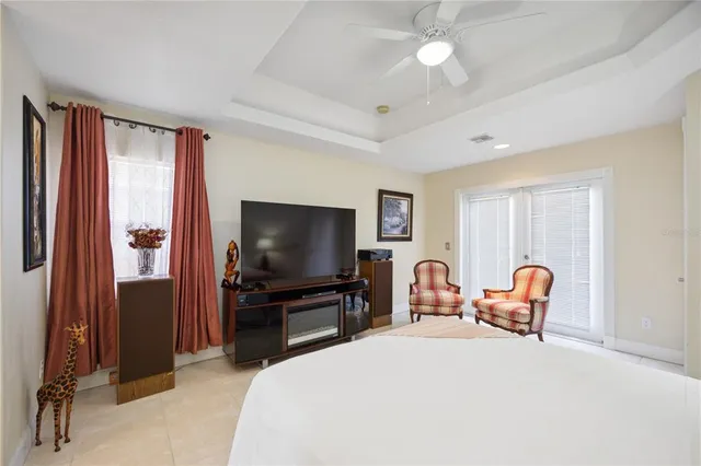 a bathroom with a granite countertop bathtub a sink and mirror
