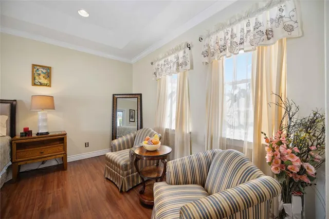 a bedroom with bed and wooden floor