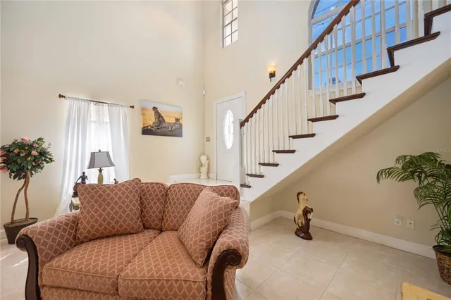 a kitchen with stainless steel appliances granite countertop a sink dishwasher and a refrigerator with wooden floor