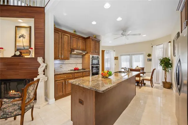 a kitchen with stainless steel appliances granite countertop a sink stove and cabinets