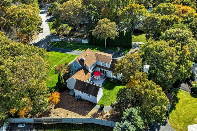 a kitchen with stainless steel appliances granite countertop a stove a refrigerator a kitchen island and chairs