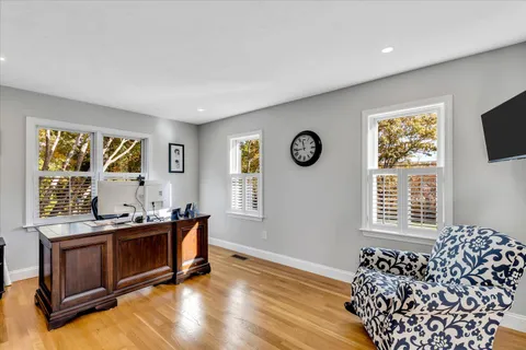 a living room with furniture and painting on the wall